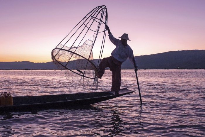 Silhouette of fisherman at sunset Inle Lake Burma Myanmar