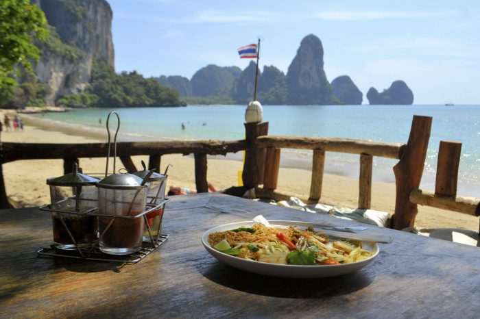 Pad Thai with chicken, traditional dish with an ocean background at Tonsai beach